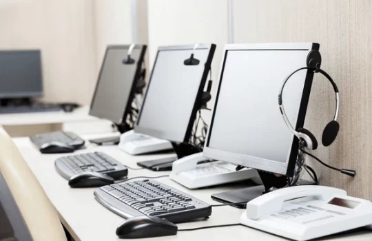 row-computers-headphones-on-desk-600nw-264982280